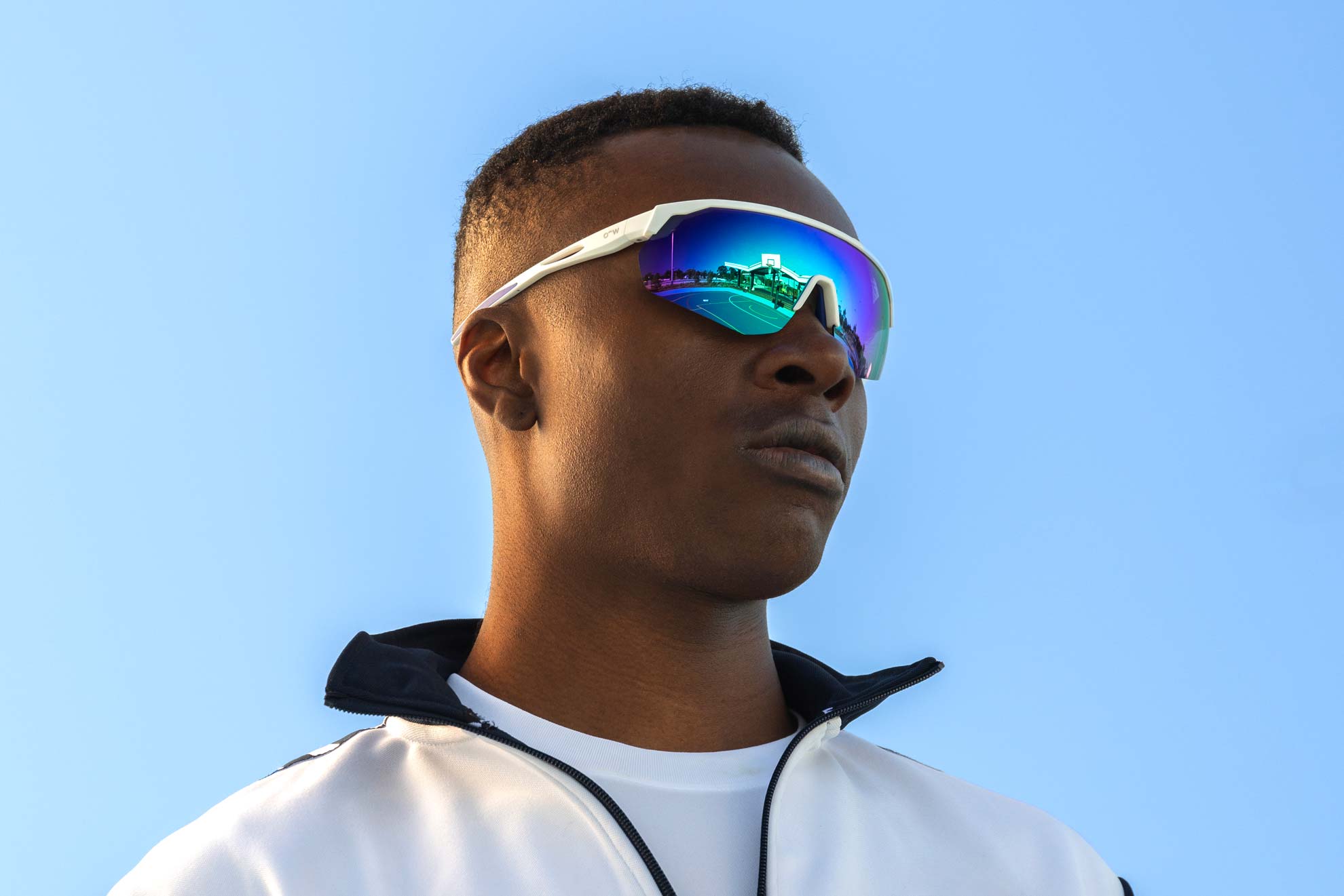 Model wearing Falcon sunglasses frame in the colour Beetle Glaze.