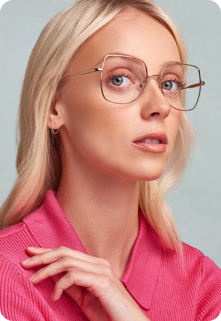 A model wearing Amber optical glasses in a 70s-inspired design.