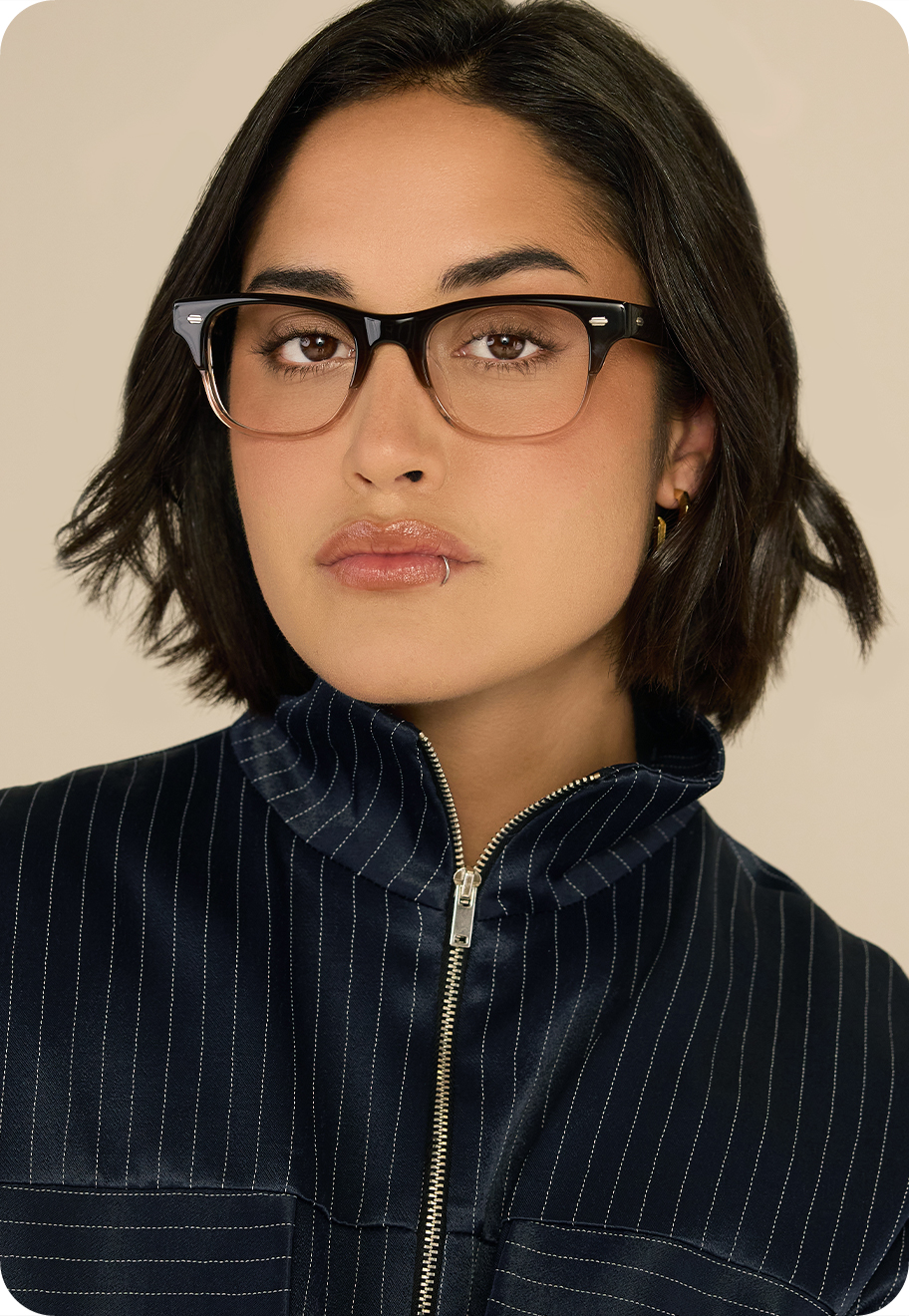 A woman wearing Kristof optical glasses in the colour Latte.