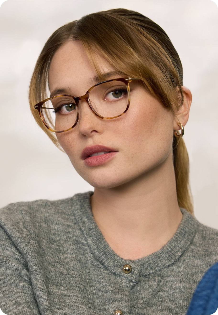Woman with square face shape and dirty blonde hair wearing Oscar Wylee lightweight glasses.