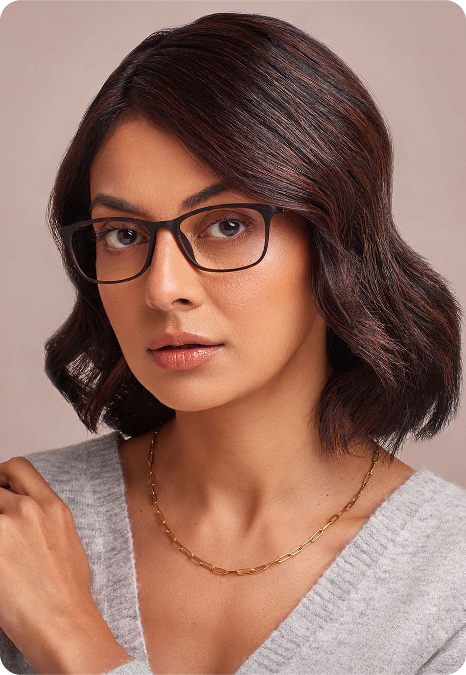 Lady with oval face shape and short dark hair wearing Oscar Wylee lightweight glasses.