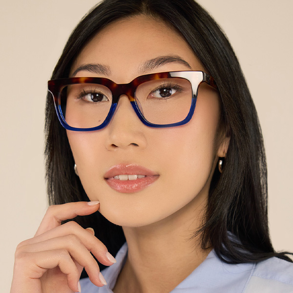 Model wearing Serge optical frame in Cobalt Tortoise.