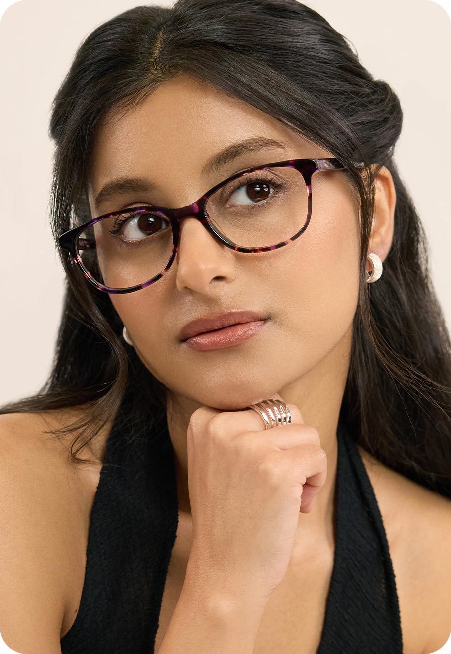 A person with dark coloured eyes, wearing dark coloured Oscar Wylee frames.
