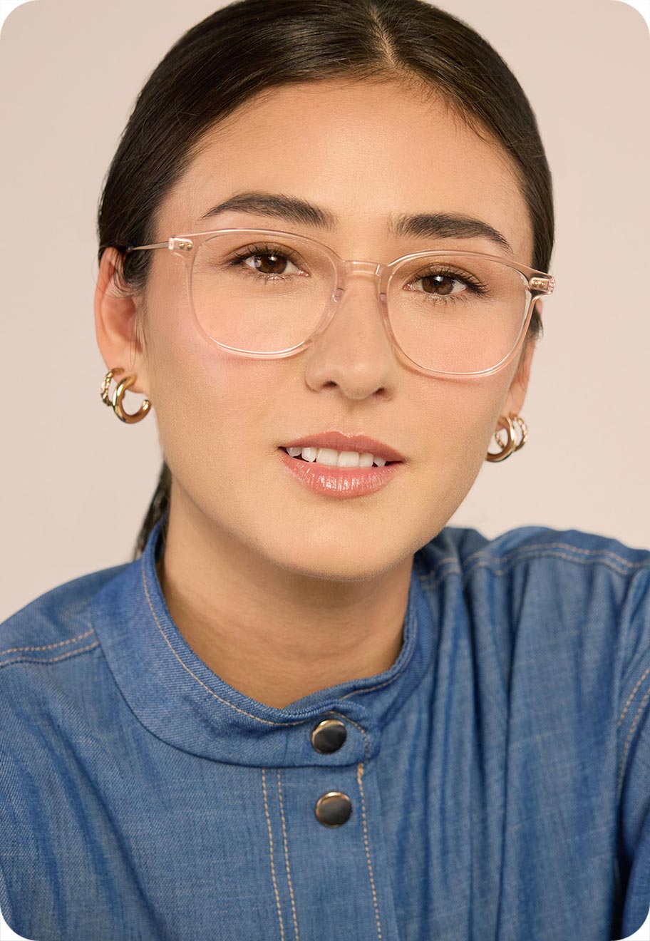 A model wearing Oscar Wylee’s Humphrey frame in wheat, which suits her skin tone.