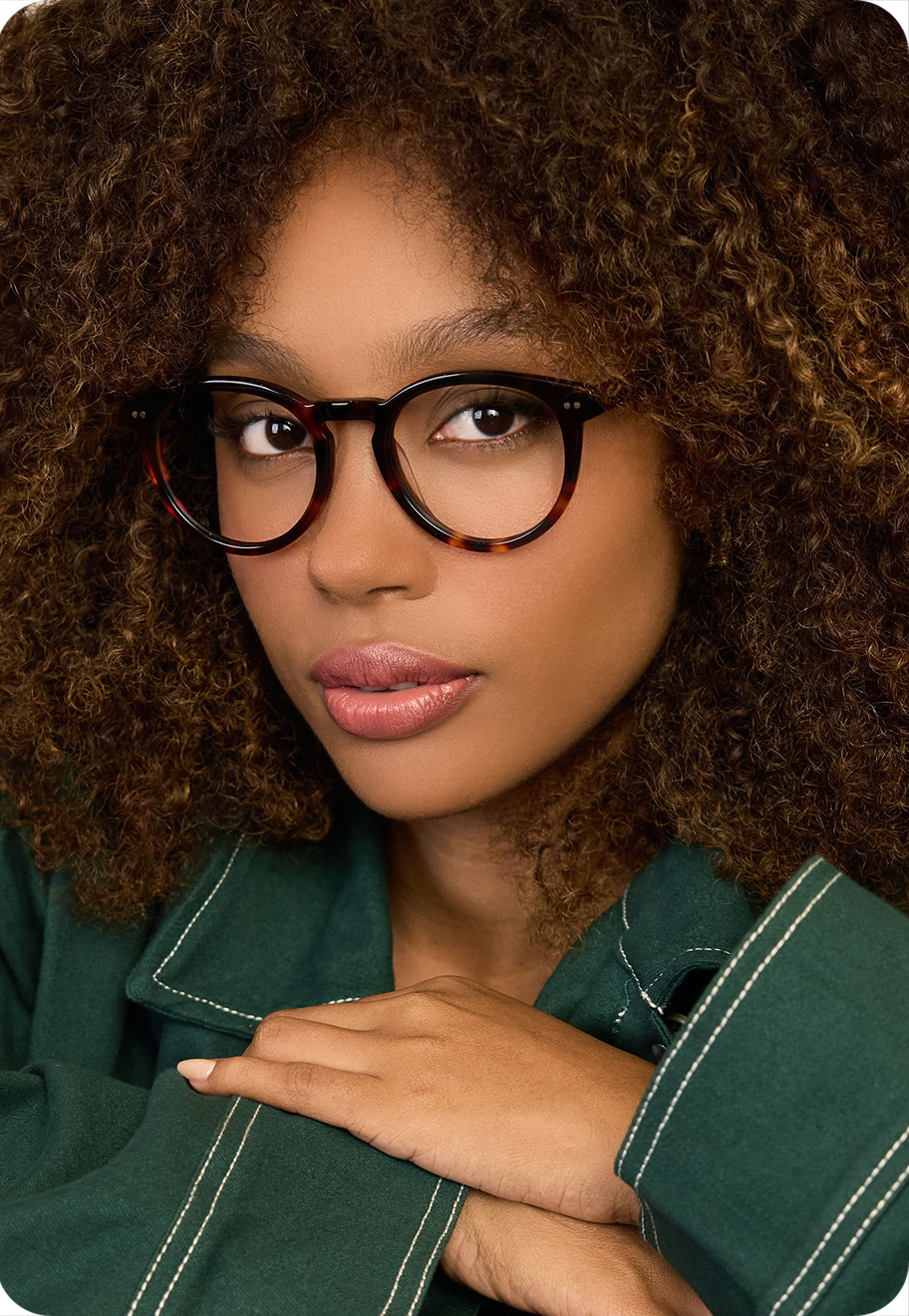 A photo of a model wearing OW Billy optical glasses in Auburn Tortoise.
