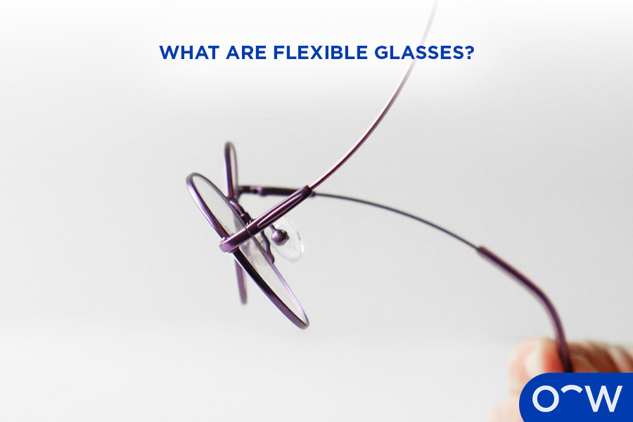 A pair of flexible glasses being bent gently.