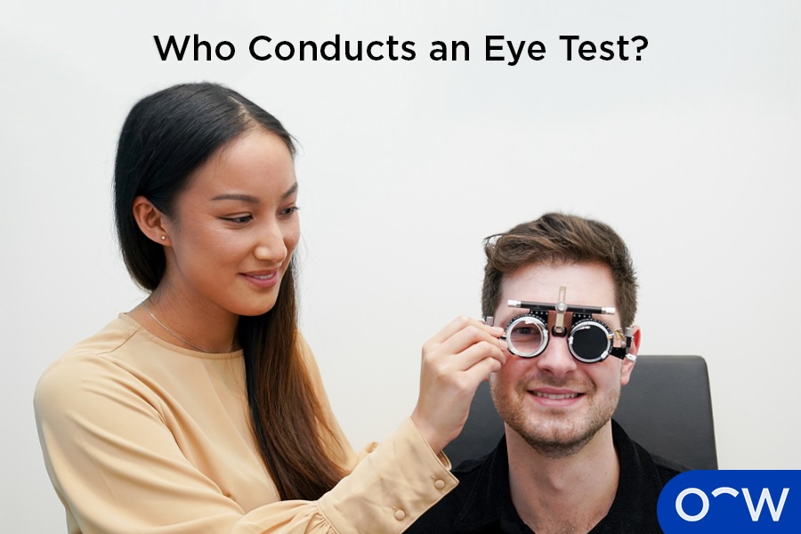 An optometrist holding the equipment necessary for conducting an eye test.
