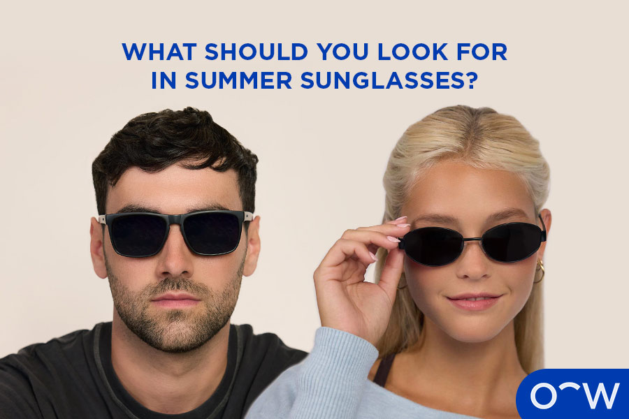 Two people smiling on the beach wearing Nolan and Cruz sunglasses.