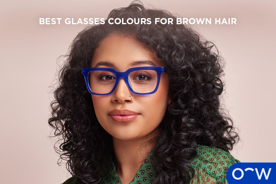 Woman with brown hair pictured wearing blue glasses.