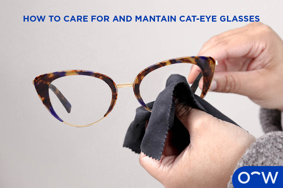 A photo of a pair of glasses being wiped with a cloth.