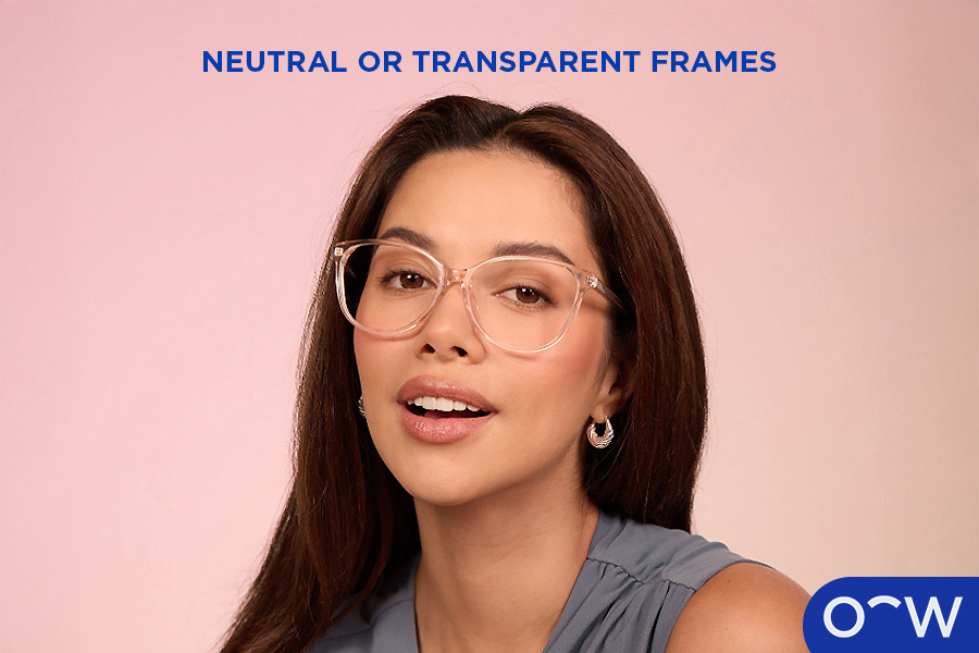 A woman posing front on with a pair of transparent glasses.