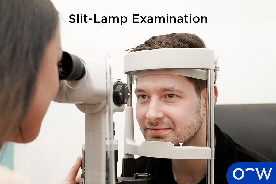 Eye care professional performing slit lamp examination on patient