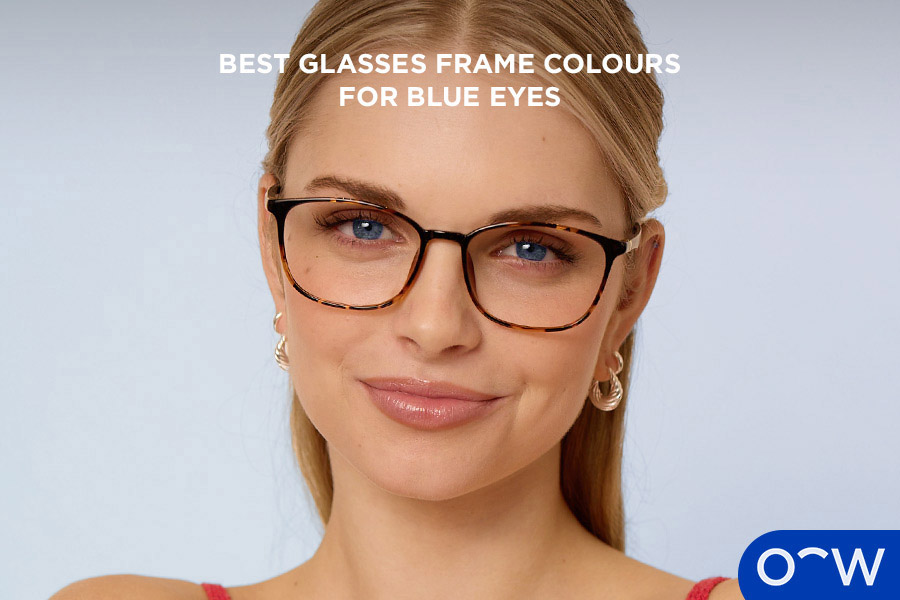 A woman with blue eyes wearing tortoiseshell glasses.