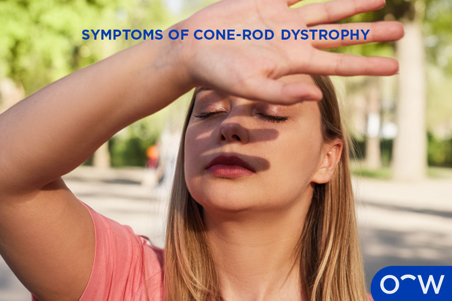 A person with light sensitivity caused cone-rod dystrophy, shielding their eyes from the light.