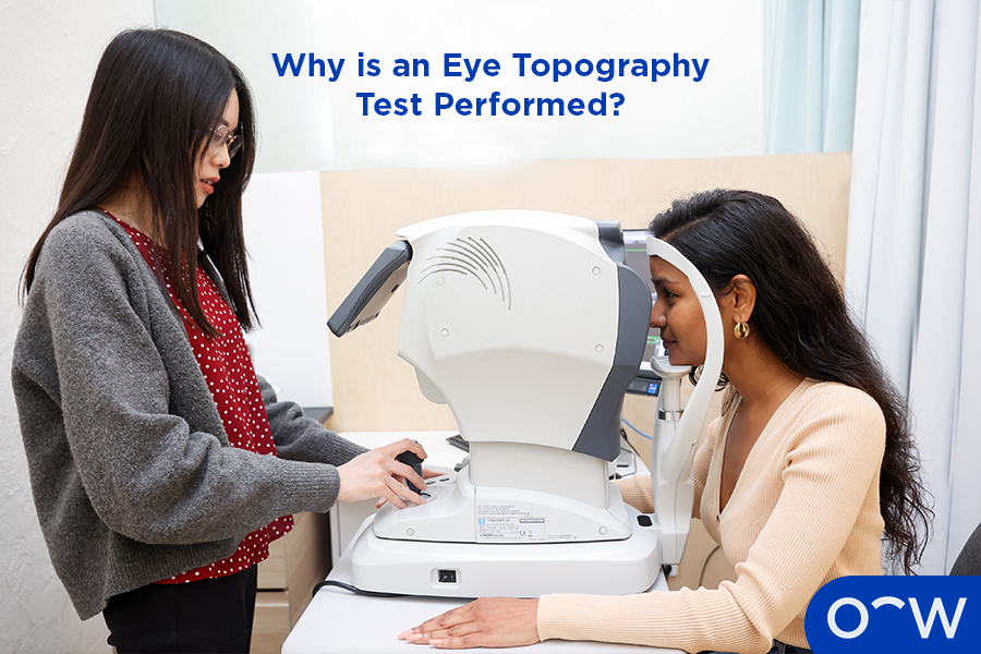 A photo of a corneal topography test being done with a computer showing the scans.