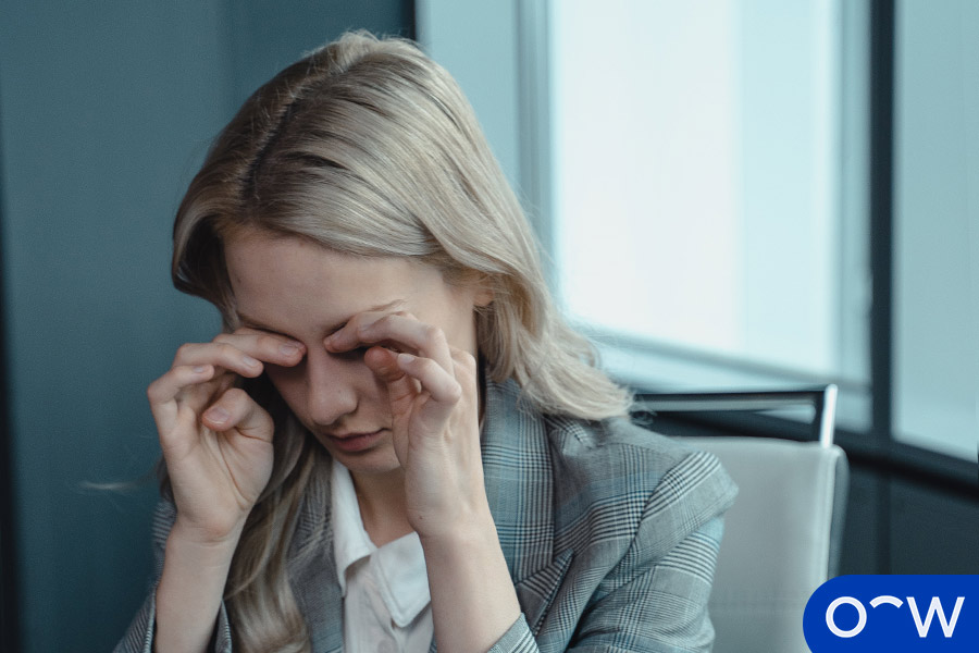 A woman holding her fingers to her eyes