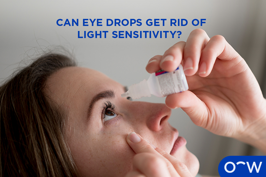Woman using eye drops to relieve light sensitivity.