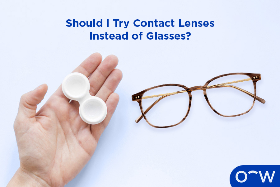 A person holding contact lenses in a case next to a pair of glasses.