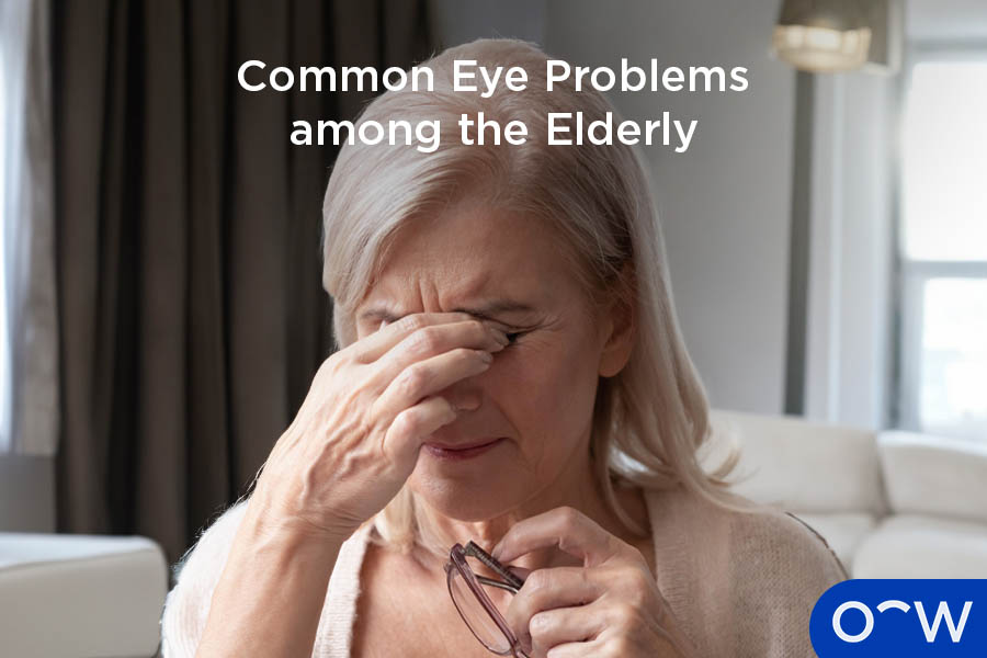 Elderly woman, experiencing an eye problem, covering eyes and holding glasses