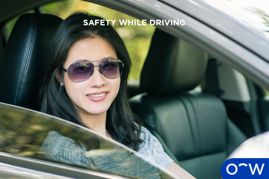 Female wearing sunglasses while driving in winter