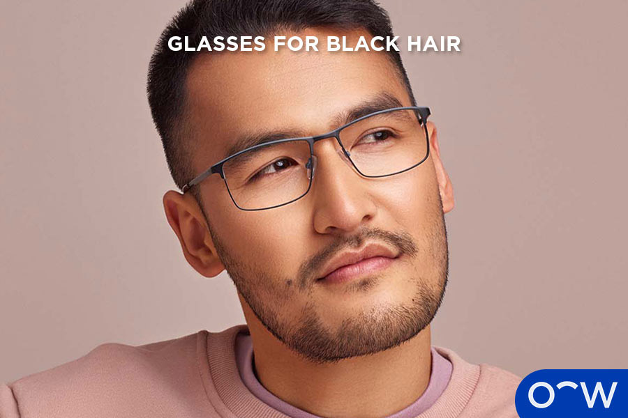 A man with black hair wearing glasses