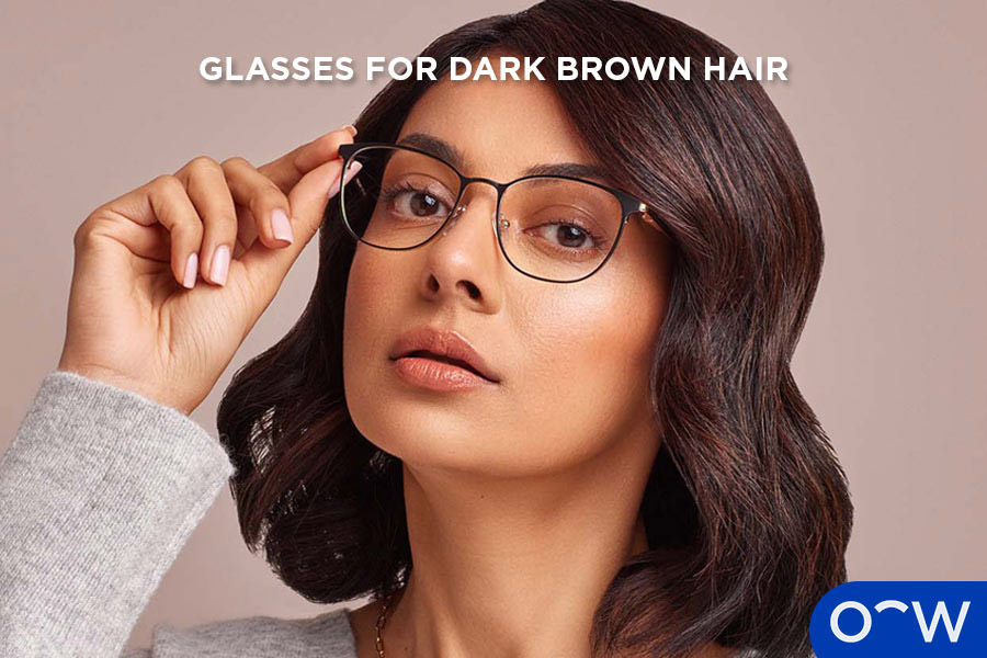 A woman with dark brown hair wearing glasses