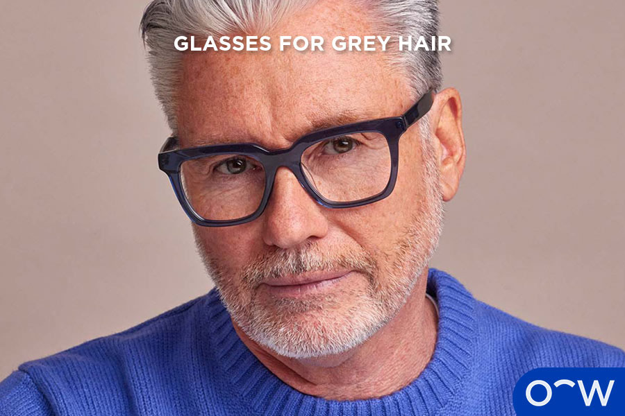 A man with grey hair wearing glasses