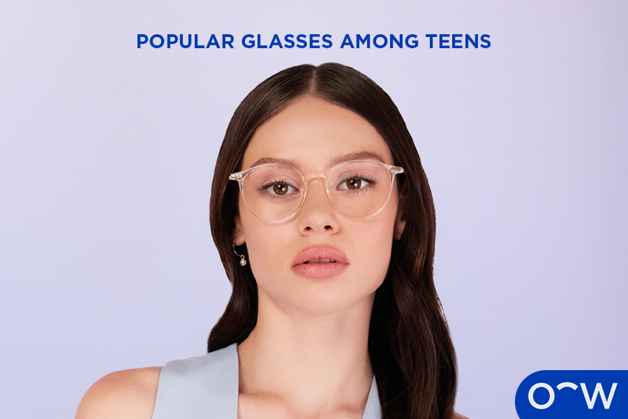 An image of a young girl wearing clear, acetate glasses.