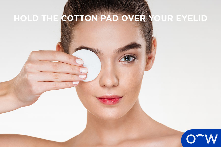Image of person holding a cotton pad over their eye