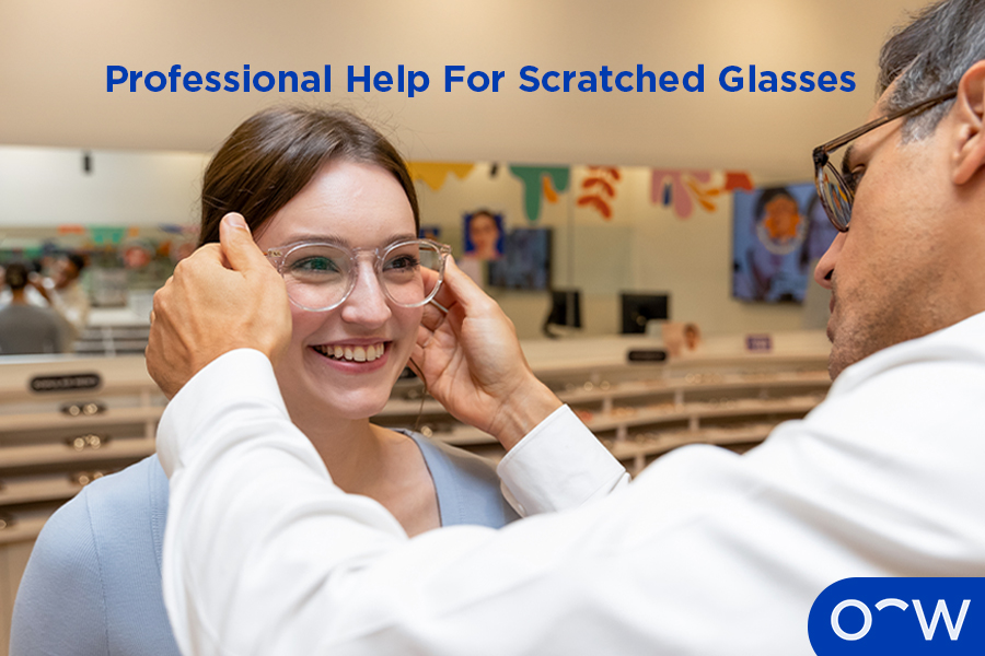 An optometrist assisting a young boy with his glasses.