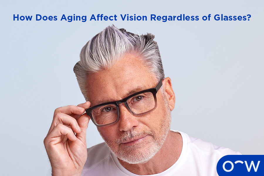 A photo of an older man wearing glasses and reading.
