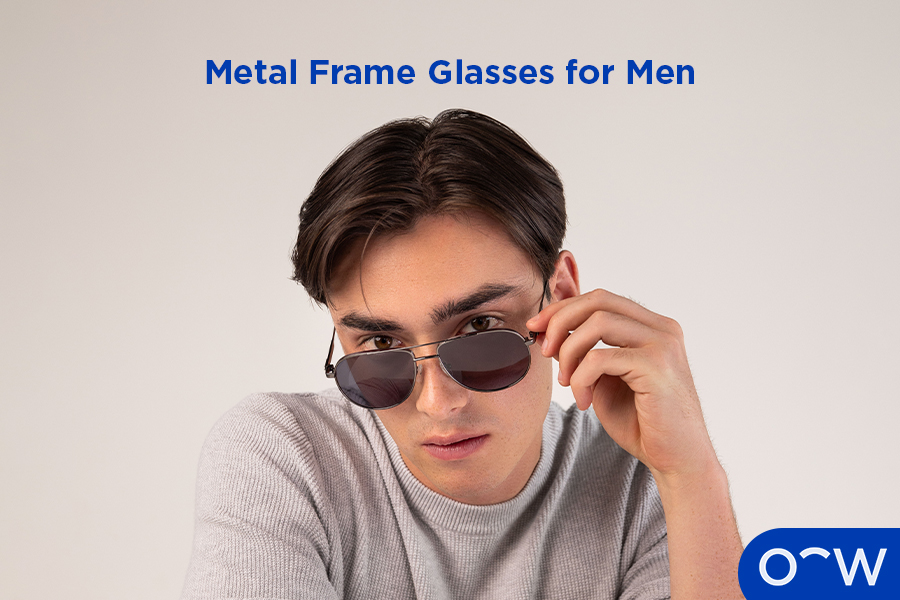 An image of a man wearing metal aviator sunglasses.