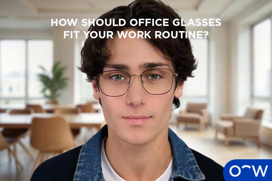 Someone working at an office desk wearing the Jas frames in Heritage Umber.