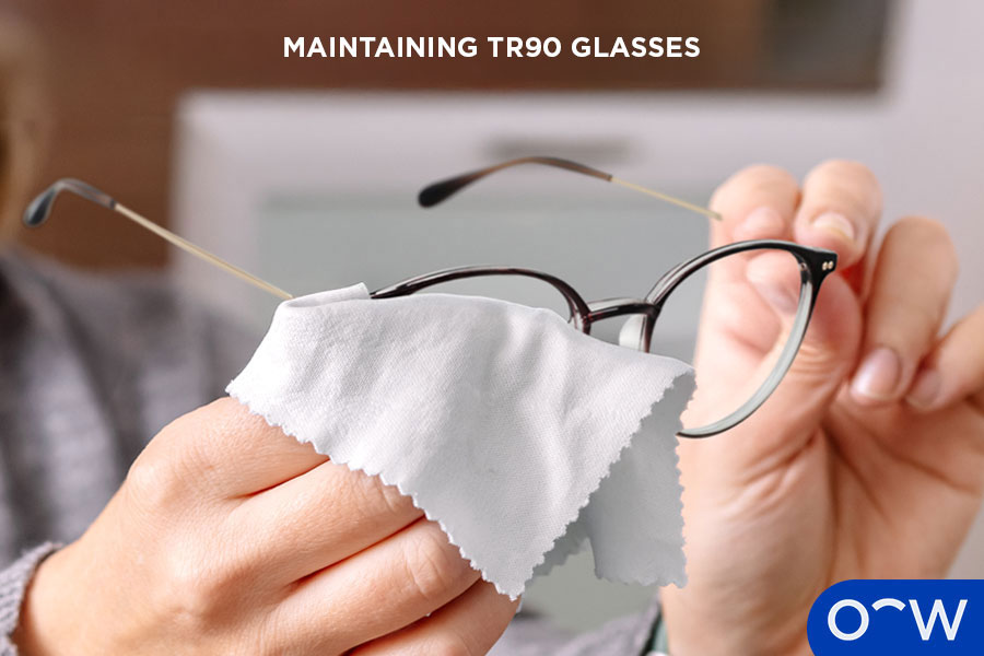 Close-up of hands cleaning TR90 glasses with a cloth