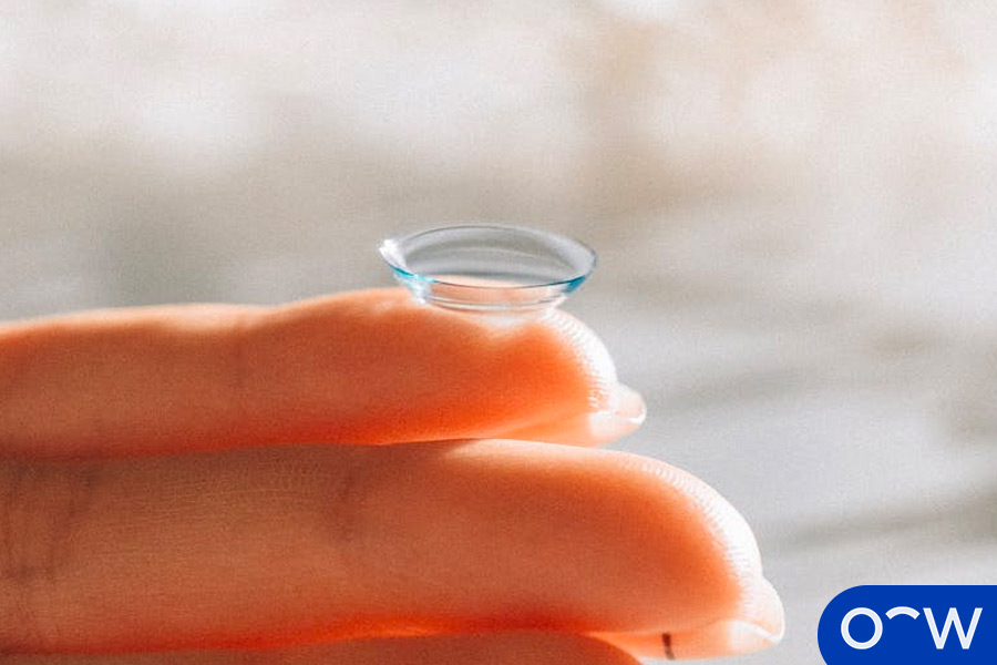Different Types of Glasses Lenses - image showing someone holding a toric contact lens on their finger.