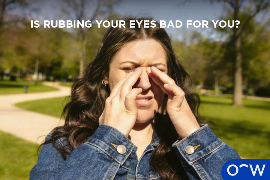 A photo of a person rubbing their eyes.