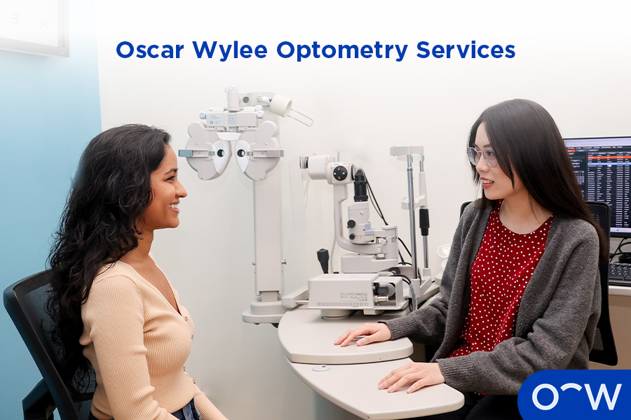 An optometrist with a customer in an eye test room.
